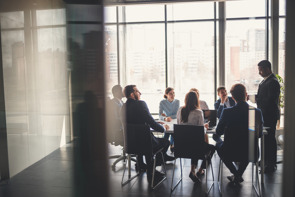 Business meeting in a conference room with eight people